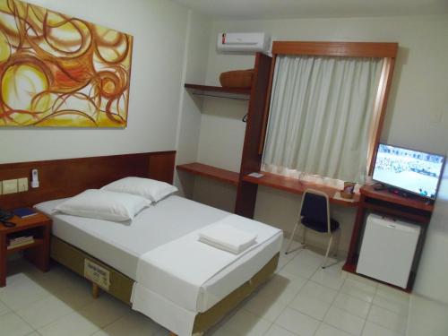 Cama ou camas em um quarto em Sanare Hotel