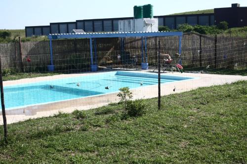 a swimming pool with a fence around it at Lala Kahle in Sodwana Bay