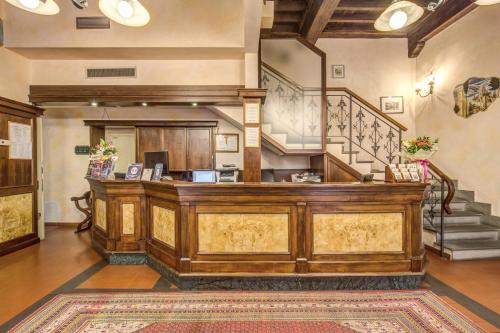 a lobby with a wooden counter in a building at Hotel De Lanzi in Florence
