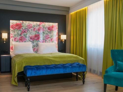 a bedroom with a bed with a floral headboard at Thon Hotel Arendal in Arendal