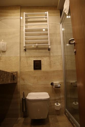a bathroom with a toilet and a shower at Hotel Golden Tulip Varna in Varna City