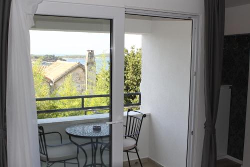 a room with a table and chairs and a window at Apartments Sunset in Hvar