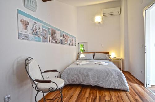 a bedroom with a bed and a chair at Lighthouse Montalbano in Rovinj