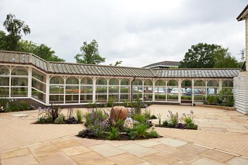 a glass greenhouse with plants in a garden at The Regency Hotel in Solihull