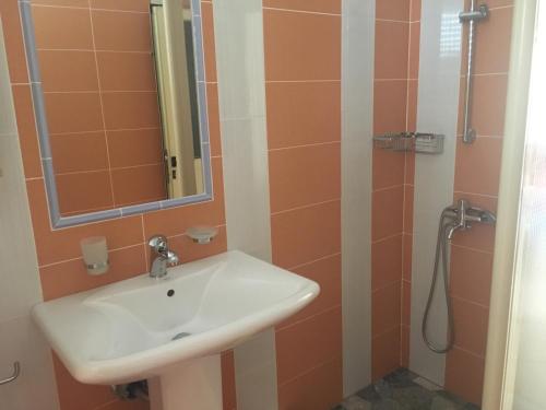 a bathroom with a sink and a shower at Villa Elvis in Orikum