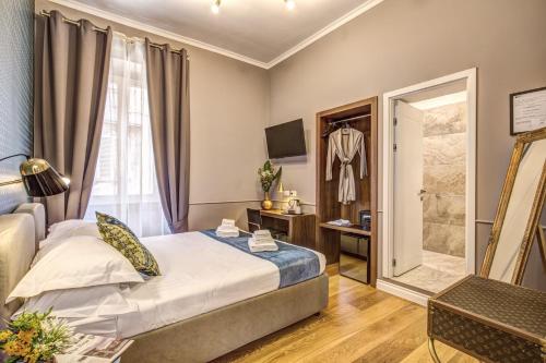 a hotel room with a bed and a walk in shower at Charme Spagna Boutique Hotel in Rome