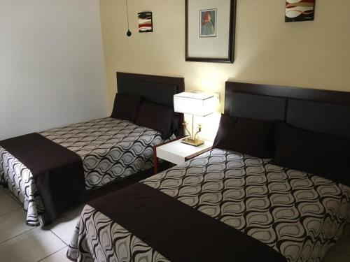 Postel nebo postele na pokoji v ubytování Hotel San Antonio