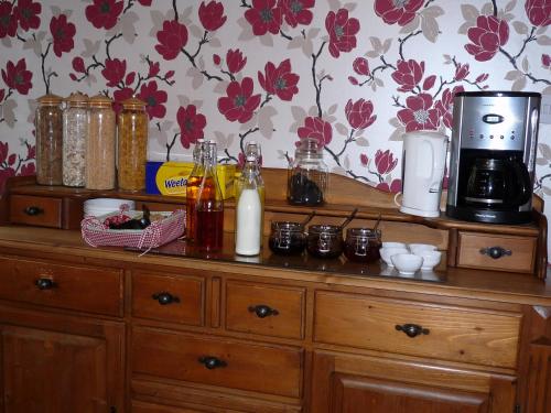 a wooden dresser with a coffee maker on top of it at Stirabout Lane B&B in Rathdrum