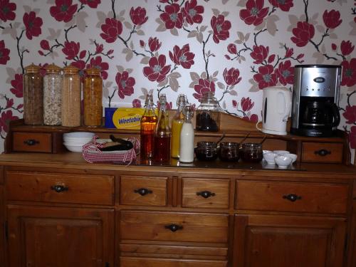 a wooden dresser with bottles on top of it at Stirabout Lane B&B in Rathdrum