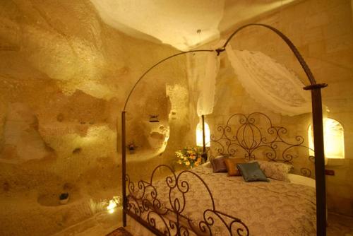 a bedroom with a wrought iron bed in a room at King Apart By Traveller's in Goreme
