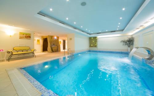 a pool in a hotel room with a swimming pool at Hotel Garden Ring in Moscow