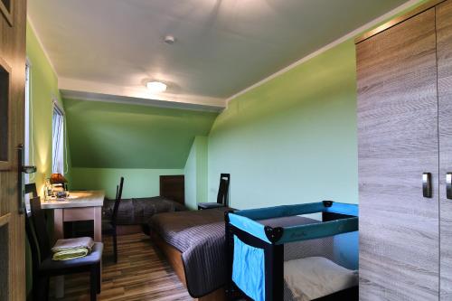 a small room with a bed and a desk at Gospodarstwo Agroturystyczne Antoniewo in Antoniewo