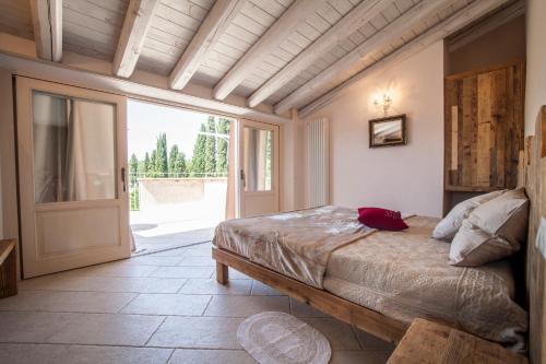 a bedroom with a bed and an open door at Casa Al Fiume in Ponti Sul Mincio