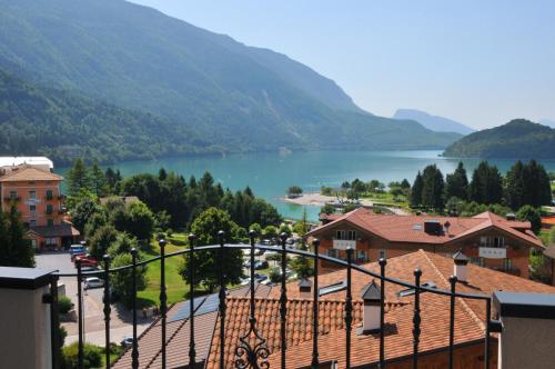 a view of a town with a lake and mountains at Alpenresort Belvedere in Molveno