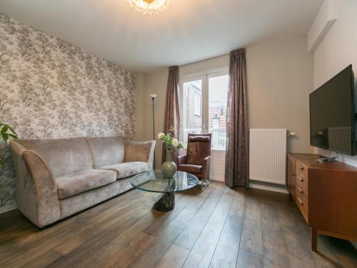 a living room with a couch and a tv at The Sunny Suite - R.Q.C. in The Hague