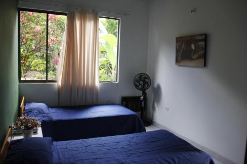 a bedroom with two beds and a window at La Provincia Casa Campestre in Rivera