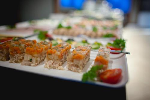 a plate of food with sushi on a table at GRANO APARTMENTS Gdańsk Motława SPA & Wellness in Gdańsk