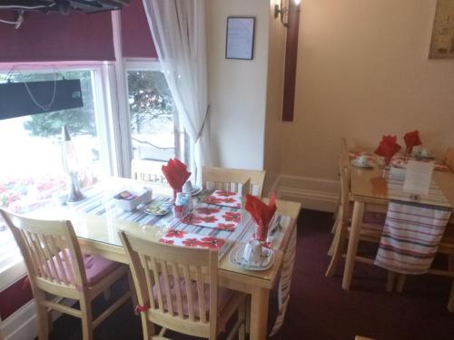 a dining room with a table and chairs at The Warwick Southport in Southport