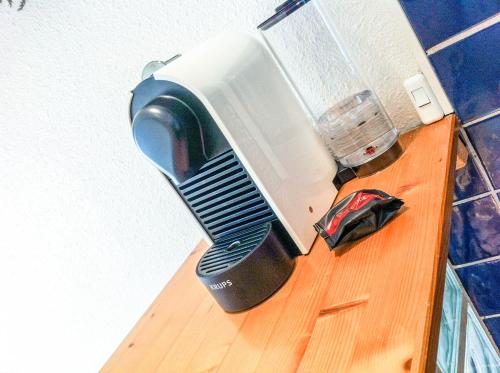 a toaster oven sitting on top of a wooden shelf at RétroMirabeau "Côté Mer" - 29m2 - LUMINEUX - TERRASSE Loggia - VUE MARINA - PARKING SECURISE - 2 à 3 pers - EMPLACEMENT TOP - Chèques Vacances CONNECT in Gruissan