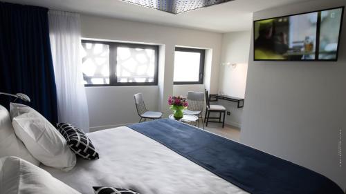 Un ou plusieurs lits dans un hébergement de l'établissement Hôtel La Fabrique
