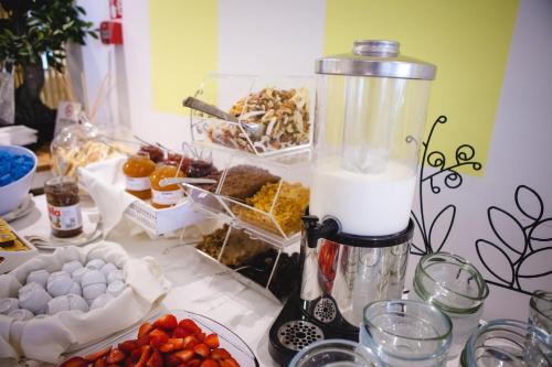 a table with a blender and a bunch of food at Hotel Speranza in Lido di Jesolo