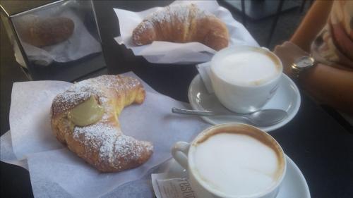 a table with two pastries and two cups of coffee at Hotel Centrale Europa in Catania