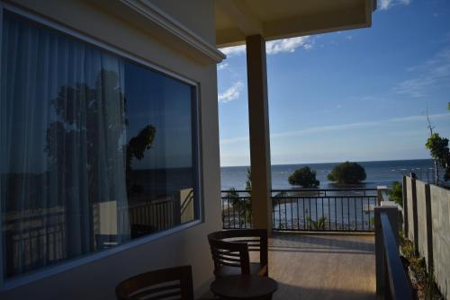 a balcony with a view of the ocean at Padadita Beach Hotel in Waingapu