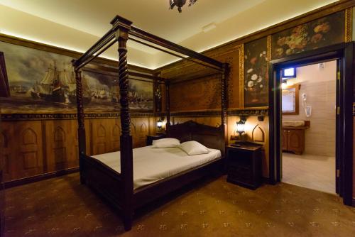 a bedroom with a canopy bed in a room at LaCetate Boutique Hotel in Piteşti