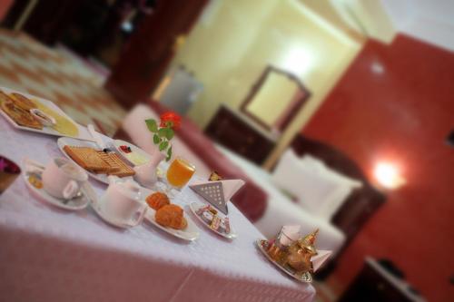 a table with plates of food on top of it at Appart Hotel Les Ambassadeurs in Marrakech