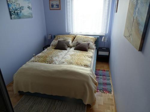 a bed in a small room with a window at Dolina Gołębiewska in Sopot