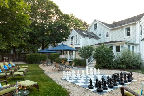 a chess board on the lawn in front of a house at West Neck Guesthouse in Shelter Island Heights
