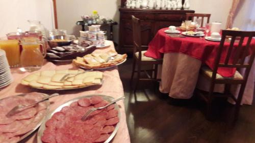 a table with plates of food on top of it at Hotel Villa Stella in Cascia
