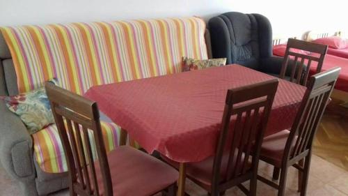a dining room with a table and chairs and a couch at Anika apart in Bar