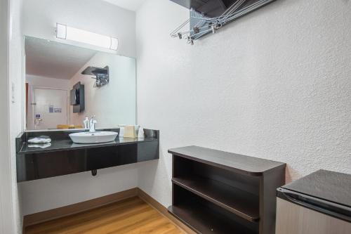 a bathroom with a sink and a mirror at Motel 6 Bakersfield in Bakersfield