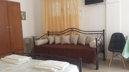 a bedroom with a bed with a glass table at Eva Apartments in Svoronata