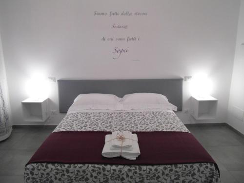 a bed with a pair of shoes sitting on it at B&B La Veranda di Gio in Torrimpietra