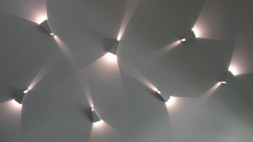 a group of lights in a room with white walls at Rest Apartment Preila in Preila