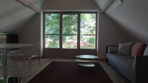 a living room with a couch and a table at Rest Apartment Preila in Preila