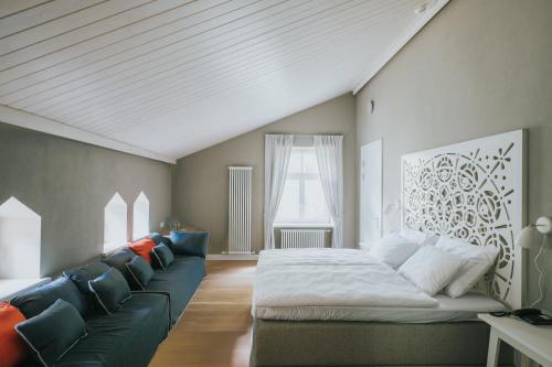 a living room with a bed and a couch at Villa Santa in Cēsis