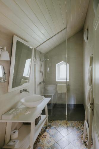 a white bathroom with a sink and a shower at Villa Santa in Cēsis