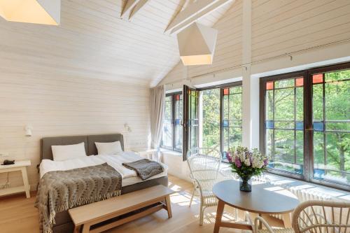 a bedroom with a bed and a table at Villa Santa in Cēsis