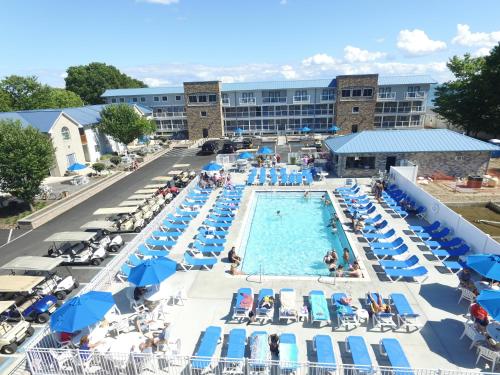 a pool with chairs and people in a hotel at Put-in-Bay Condos in Put-in-Bay