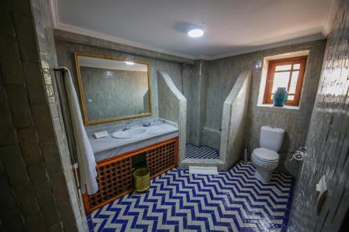 a bathroom with a sink and a toilet at Palais Nazha Fes - Luxury Lodging in Fès