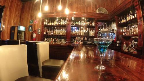 a bar with a wine glass on a wooden table at Hotel Santa Fe in Tlatlauquitepec