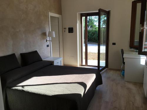 a bedroom with a bed and a sliding glass door at Villa Artemis in Nemi
