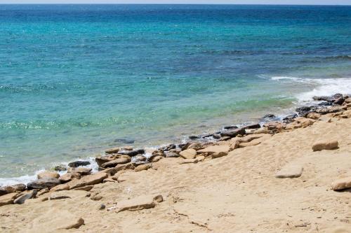 a group of rocks on a beach near the water at Masseria Sorani in Manduria