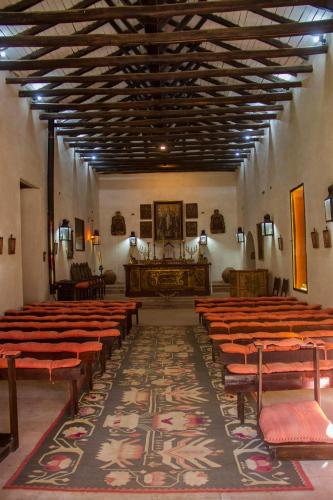 a church with rows of chairs and a altar at Hacienda los Lingues Chile Valle de Colchagua in Los Lingues