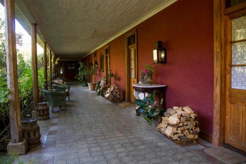 an empty hallway of a house with a room with trees at Hacienda los Lingues Chile Valle de Colchagua in Los Lingues