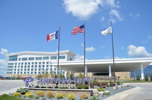 a regenstein city gaming resort with flags in front of it at Rhythm City Casino & Resort in Davenport