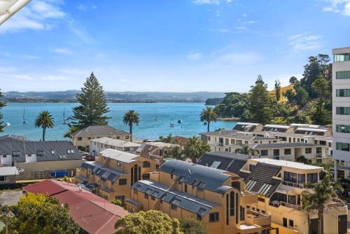 arial view of a city with buildings and a body of water at Ocean View Beach Escape - Top Floor Apartments, Mt Maunganui Base in Mount Maunganui